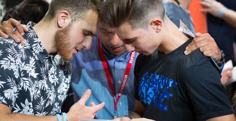 Young men respond to the invitation to prayer, at Adelaide Arena.