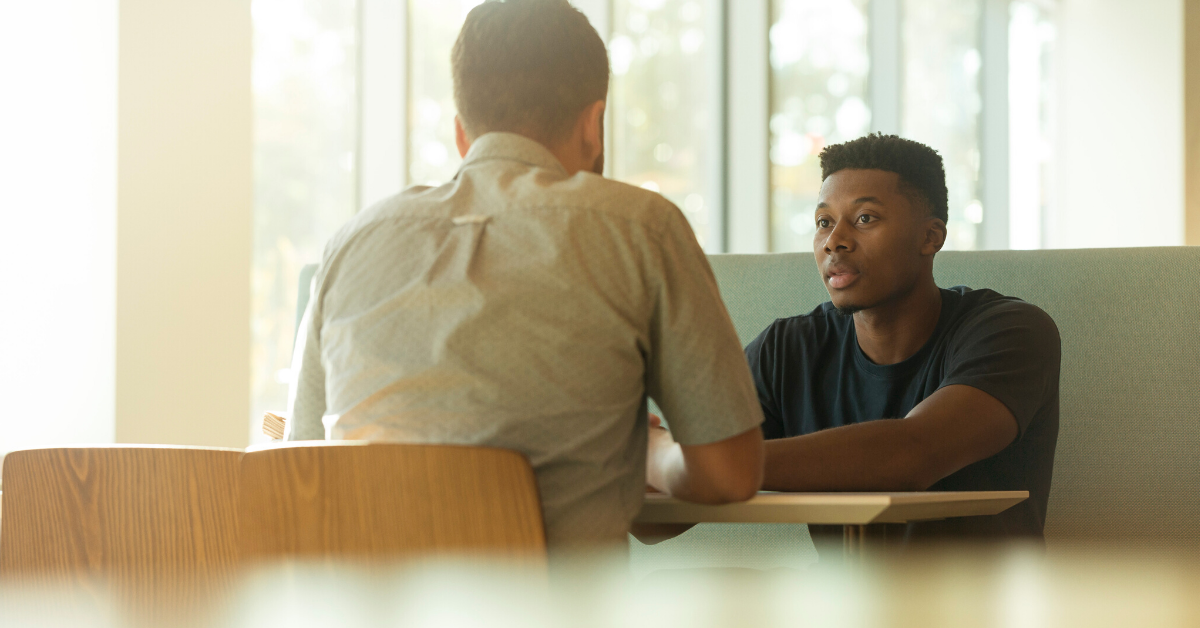 two men talking together