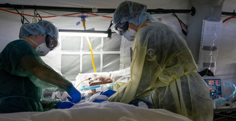 Staff caring for a patient in the field hospital in Italy