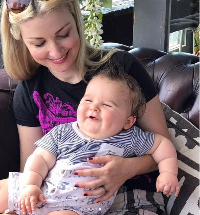 Kate holding her baby Ernie and both smiling