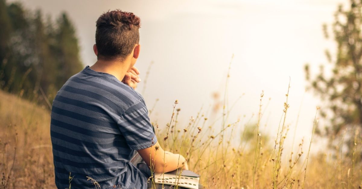 Man praying in a field 
