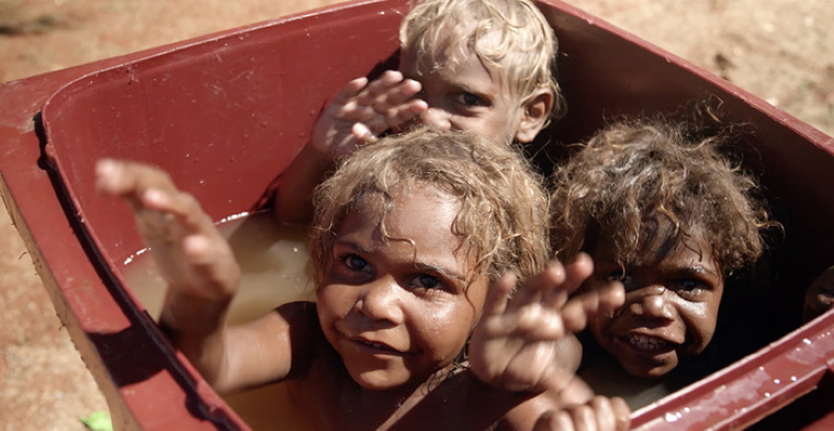Next generation: Warakurna kids Gordon, Garrick Jnr and Tristan Robinson have a bright future as some of the troubled culture of the past has changed for the better. Photo: Cinema Australia