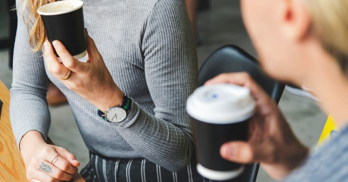 two women talking over coffee