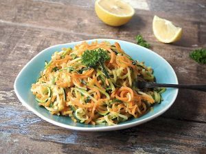 Vegetable pasta in blue dish on timber table